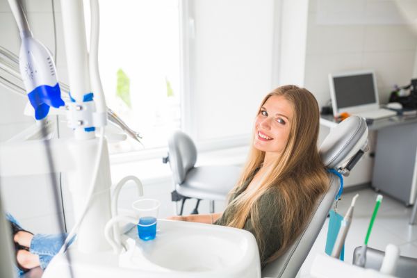 happy young woman in dentist chair